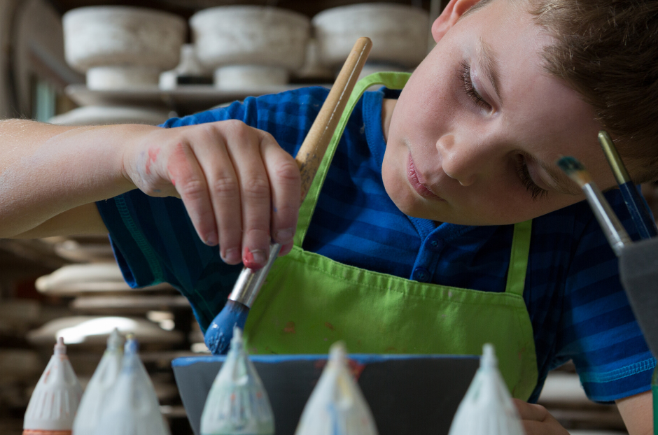 The Honiton Pottery Workshop - child painting ceramic
